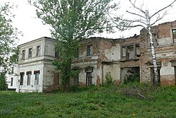 A dilapidated white building